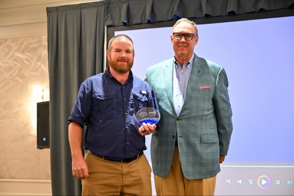 Chad Eggers (left) of Carolina Water Service of North Carolina, accepts the 2025 Living Water Award from NAWC President and CEO Rob Powelson (right). Photo courtesy of NAWC.